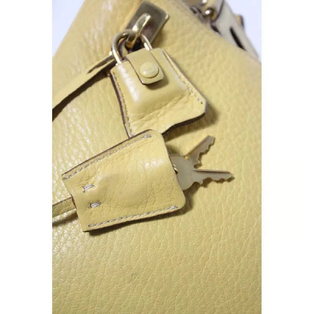 Vintage 90s Prada, yellow grained leather, hobo-style satchel with top zip, gold hardware, & padlock/keys