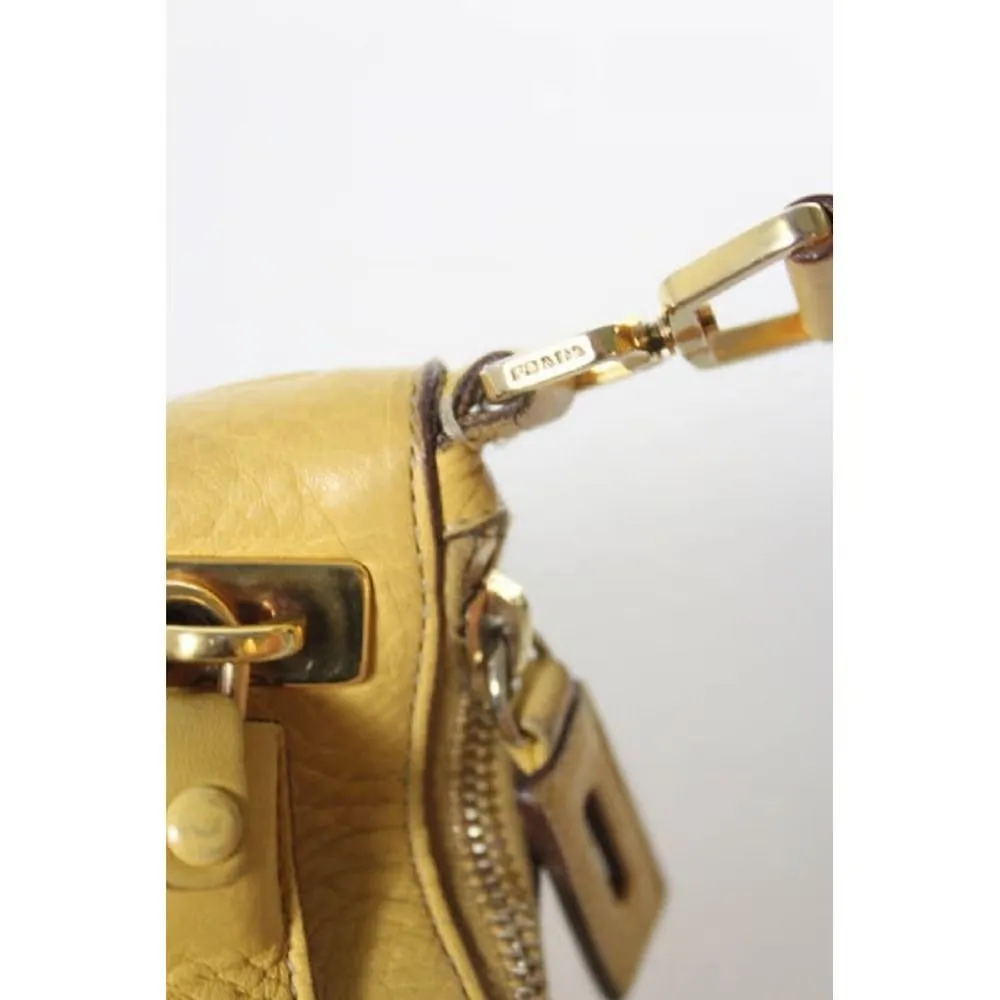 Vintage 90s Prada, yellow grained leather, hobo-style satchel with top zip, gold hardware, & padlock/keys